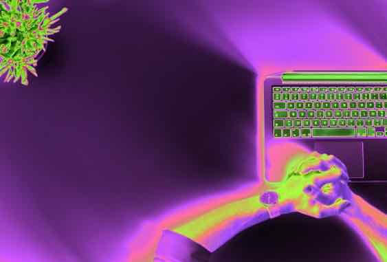 green and purple computer with hands